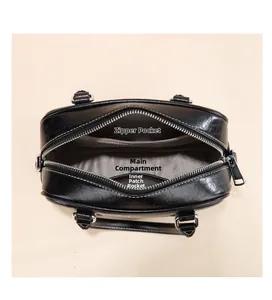 Top view showing the spacious main compartment, inner zip pocket, and lining of black bag