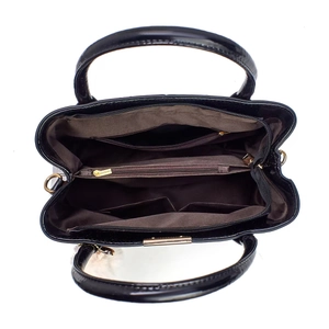 Internal view of black patent leather handbag showing multi-layer compartments and lining