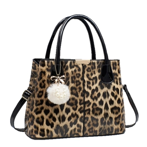 Leopard print crossbody bag with glossy patent leather, pearl charm and plush ball accent