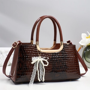 Deep brown crocodile embossed tote bag with elegant pearl lace bow charm for women