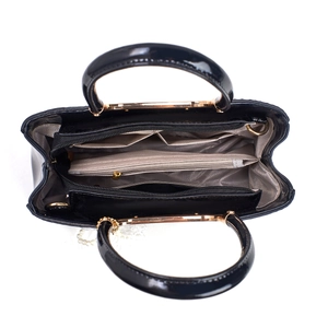 Internal layout of black patent leather handbag with multi-compartment lining and gold zippers