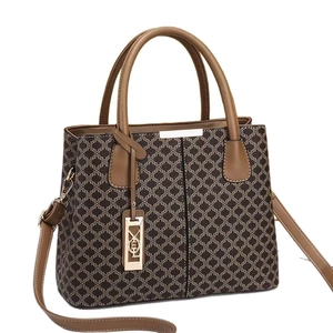 Women's vintage floral tote bag with brown leather handles and adjustable shoulder strap