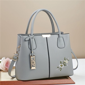 Gray embroidered leather handbag with daisy detail and adjustable shoulder strap