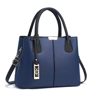 Deep blue and black leather tote bag with gold hardware and stylish metal charm