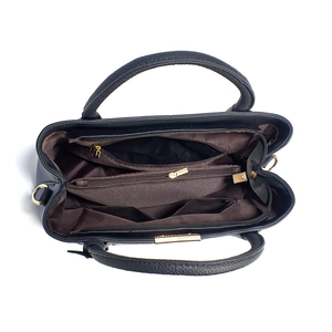 Vertical view of the spacious inner compartments with zippers and brown fabric lining