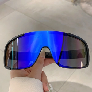 Close-up of blue mirrored oversized lenses on matte black sports cycling sunglasses