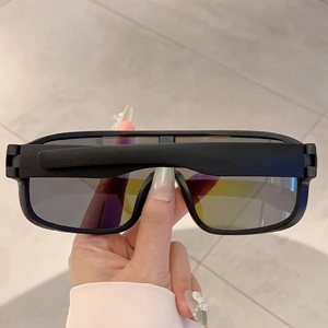 Detailed close-up of black matte frames and dark grey wrap-around lenses for outdoor sports