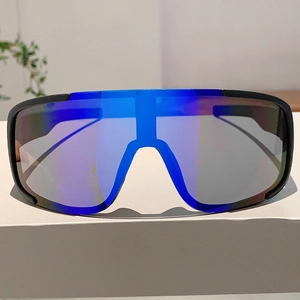 Close-up of sports sunglasses with blue-purple gradient reflective lenses on white desk