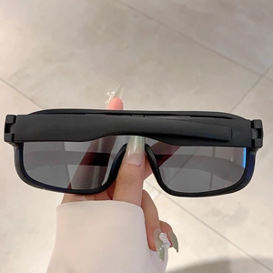 Close-up of matte black frame and dark grey lenses on large sports sunglasses