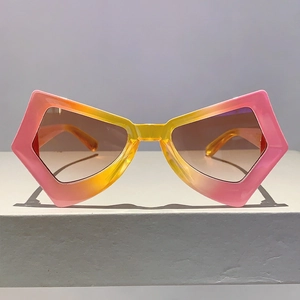 Front view of geometric butterfly sunglasses with pink and yellow gradient frames