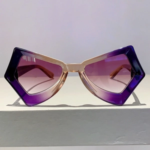 Macro shot of stylish butterfly wing sunglasses with purple gradient lenses and frames