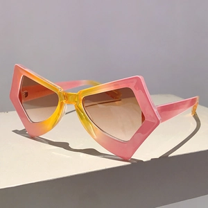 Side view of star-shaped sunglasses with pink-yellow gradient frames on white surface