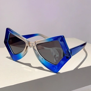 Angled view of trendy butterfly sunglasses with blue gradient frames on a display stand