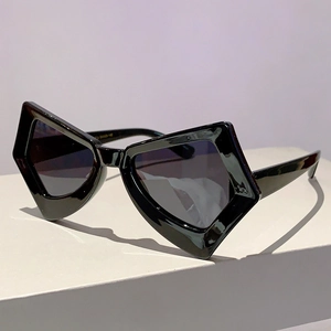 Detail of oversized geometric butterfly sunglasses with polished black frames and dark lenses