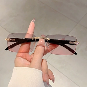 Unisex rimless sunglasses with gradient pink lenses and black faux wood temples