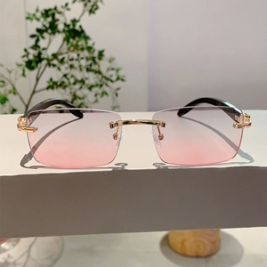 Detail of rimless sunglasses with pink gradient lenses and elegant metal bridge