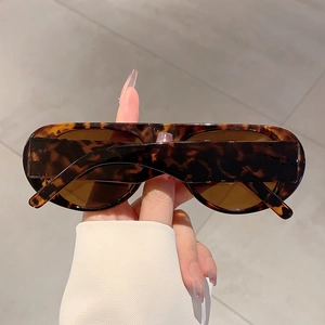 Close-up of retro tortoiseshell sunglasses with thick frames and dark brown lenses