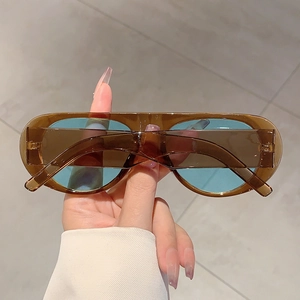 Detail of retro oval sunglasses with brown resin frame and light blue lenses