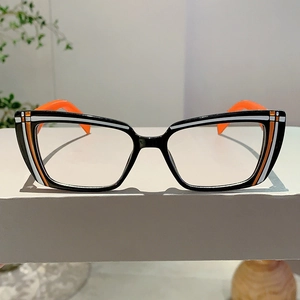 Detailed view of cat-eye glasses frame with orange and white striped accents