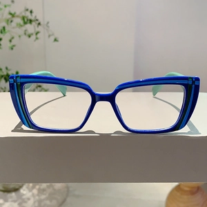 Detail of blue and green cat-eye glasses frame with elegant striped textures