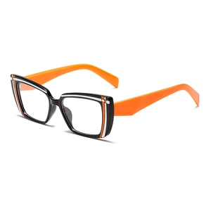 Retro oversized two-tone eyeglasses with bold black white frames and bright orange temples