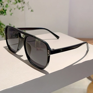Detailed side view of black vintage square sunglasses with silver rivet accents