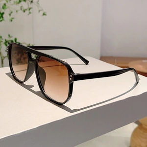 Detailed side view of vintage square sunglasses with silver rivets and gradient lenses