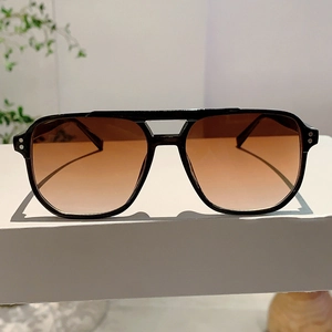 Detail of square vintage sunglasses with double bridge and metal stud accents
