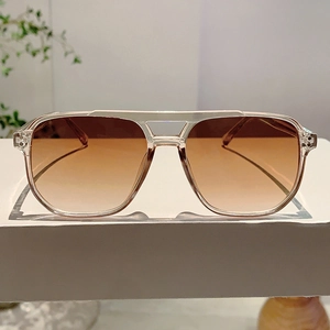 Detail of transparent champagne frames with brown gradient lenses and retro double bridge