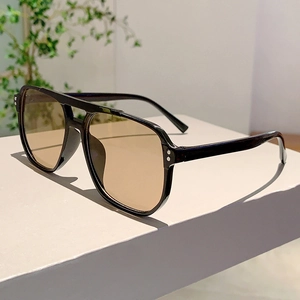 Detail of vintage aviator sunglasses featuring double bridge and silver rivet accents