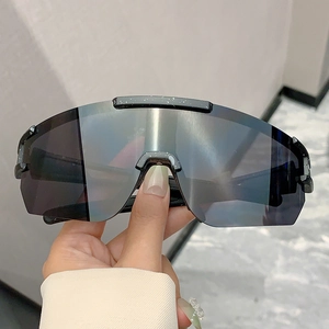 Detail of polarized cycling sunglasses featuring white paint splatter design on the frame