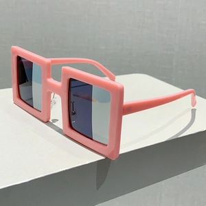 Detail shot of chunky pink square sunglasses on white geometric display stand