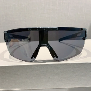 Detail of sports sunglasses with black frame and unique white speckled spray texture