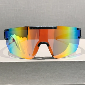 Front view of colorful mirrored shield sunglasses on a gray display block for sports