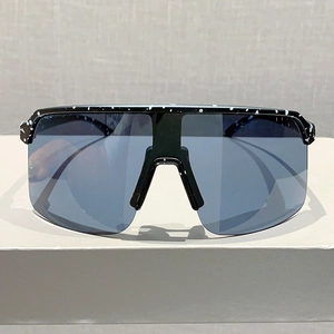 Front view of shield sunglasses with black frame and white splatter pattern for sports