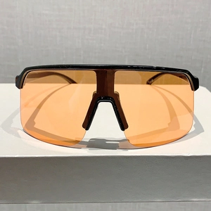 Detail of oversized orange lenses with black frame for outdoor cycling sunglasses