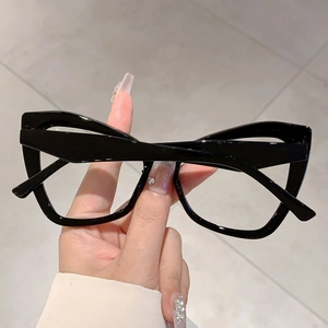 Macro view of black cat-eye glasses frame with sleek finish and oversized retro design