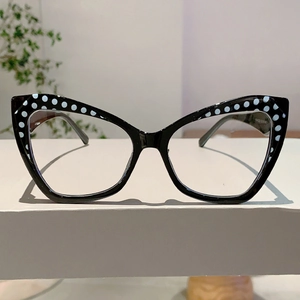 Detail view of TR90 cat-eye glasses frame featuring white polka dots on black finish