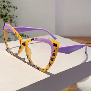 Detail of cat-eye glasses frame featuring tri-color leopard pattern on a stone base