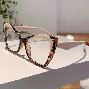 Close-up of cat-eye glasses with brown tortoiseshell and cream white contrast frame