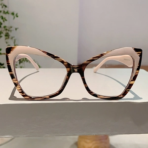 Detail of retro cat-eye glasses frame with tortoise and pink color-blocking finish