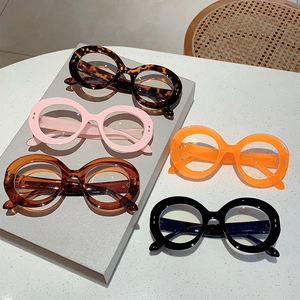 Retro oversized round frame blue light glasses in tortoise, pink, and orange finishes