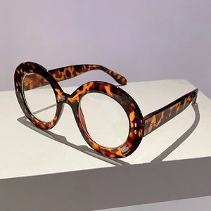 Close-up of retro tortoiseshell round frame glasses with vintage textured leopard pattern