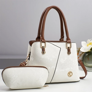 Detail of white snakeskin texture handbag with brown handles and golden metal K logo