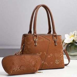 Detailed macro view of the brown snakeskin texture and golden K logo on the Boston handbag