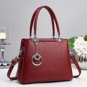 Premium red litchi grain leather handbag with silver pendant and adjustable strap