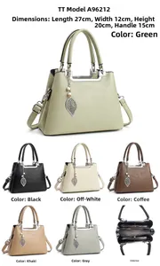 Detail of soft leather handbag interior compartments and leaf charm accessory