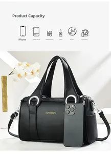 Detail of black pebbled leather Boston bag with large capacity compared to a phone