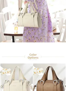 Detail view of stylish pebble leather boston bags in cream and coffee brown colors