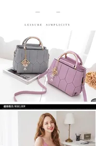 Detail showing honeycomb quilted faux leather and round metal handle of women's handbag